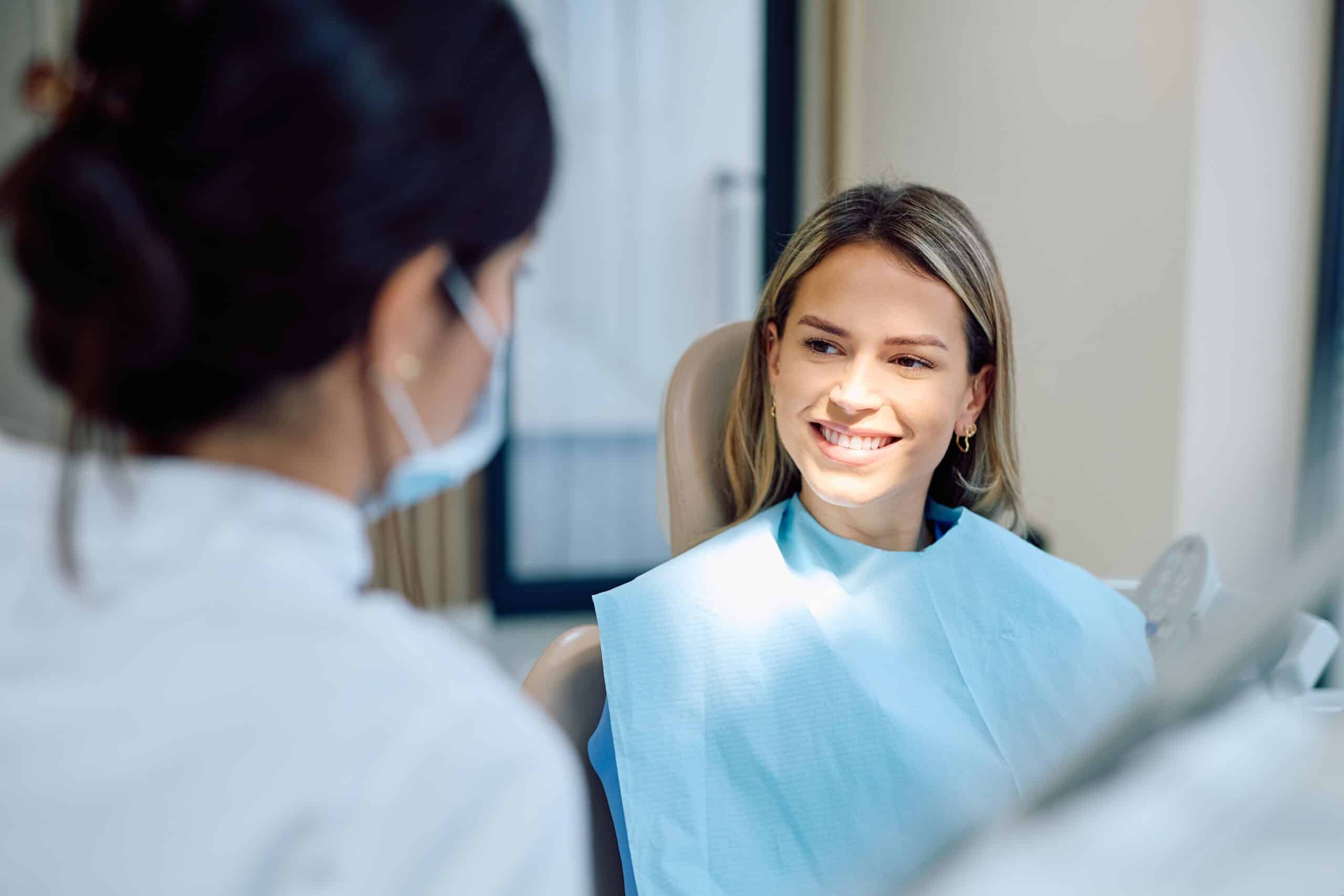 Young,Woman,Sitting,In,A,Dental,Chair,Smiling,At,A