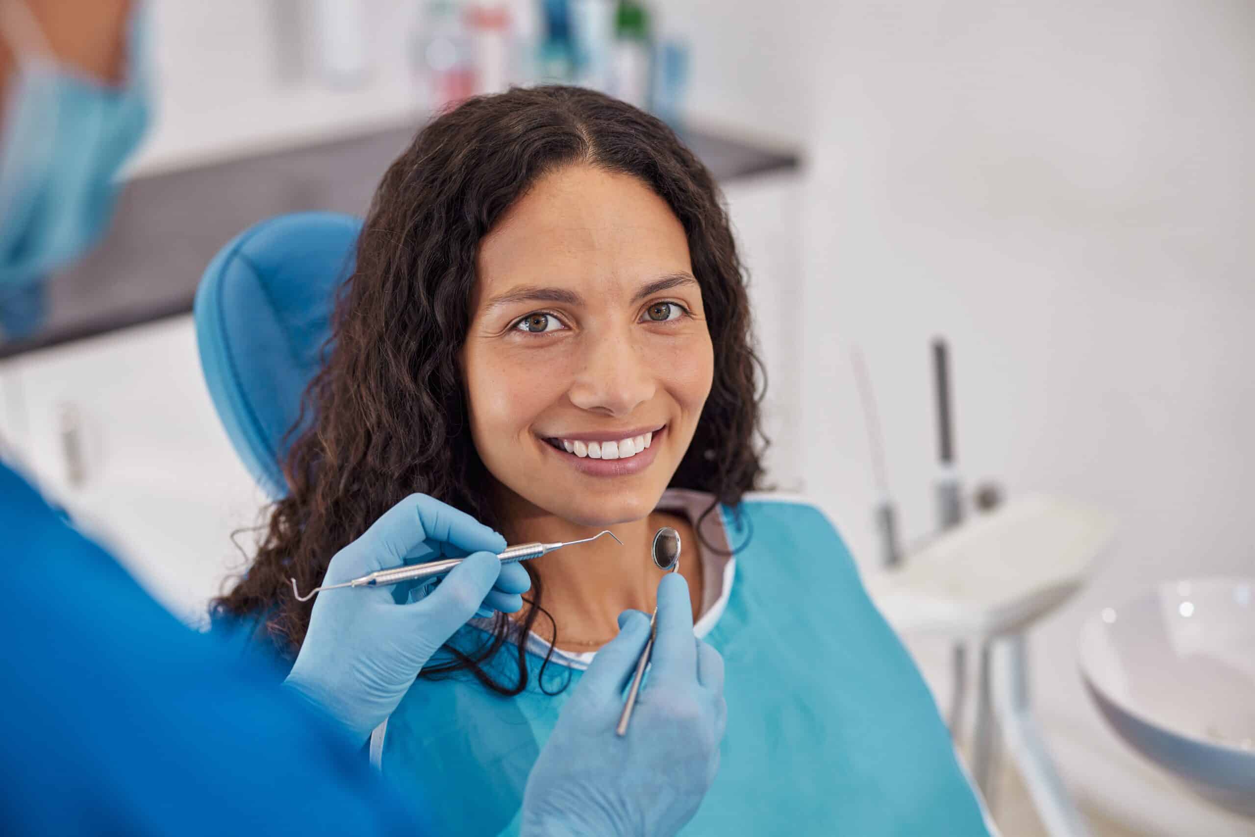 Happy,Young,Patient,Smiling,While,Sitting,In,Dental,Chair,During