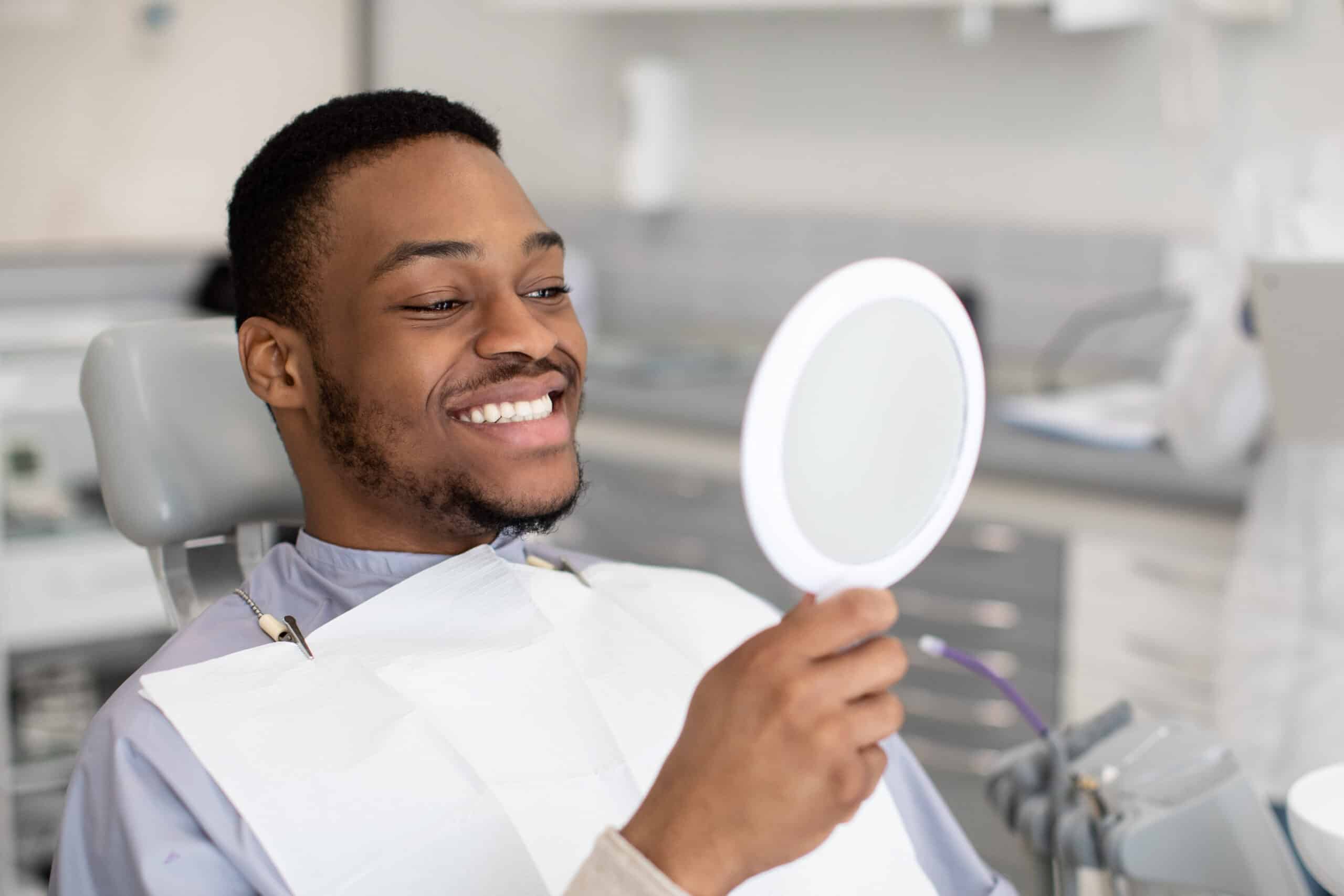 Portrait,Of,Happy,Dental,Clinic,Patient,Looking,At,Mirror,After