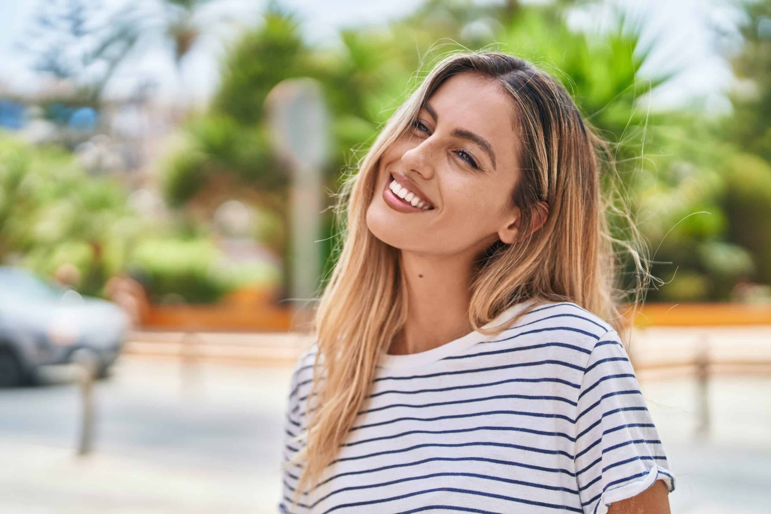 Young,Blonde,Woman,Smiling,Confident,Looking,To,The,Side,At