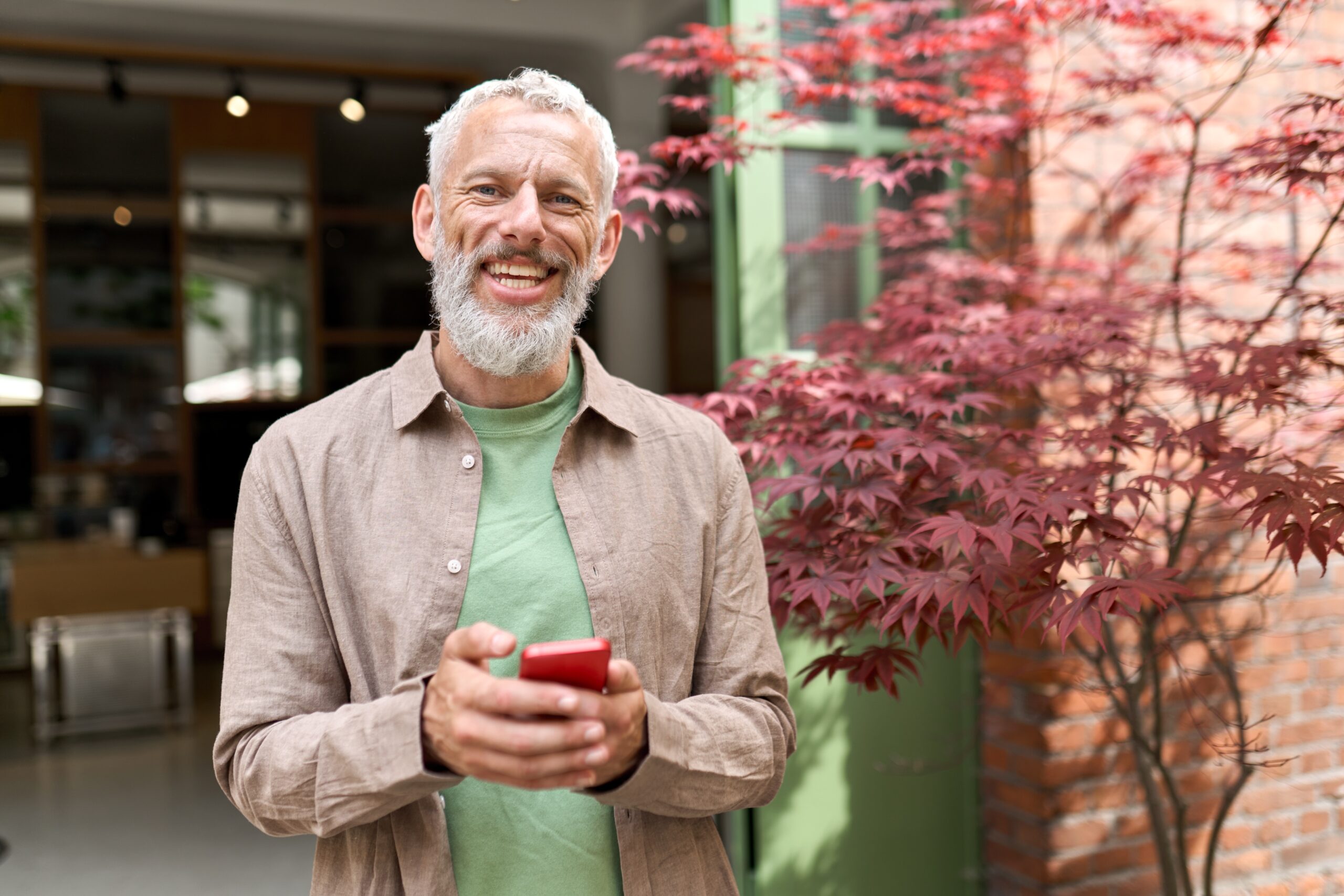 Smiling,Gray-haired,Older,Middle,Aged,Bearded,Man,Using,Mobile,Phone